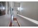 Hallway with hardwood floors, neutral paint and decorative lighting at 102 Brent Cir, Oldsmar, FL 34677