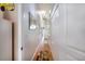 Bright hallway showcasing wood flooring, a skylight, and decorative lighting and storage at 102 Brent Cir, Oldsmar, FL 34677