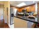 This well-lit kitchen features stainless steel appliances, granite counters, and wood cabinets at 102 Brent Cir, Oldsmar, FL 34677