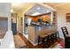 Well-lit kitchen with stainless steel appliances, breakfast bar seating, and wood cabinetry at 102 Brent Cir, Oldsmar, FL 34677