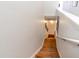 A staircase featuring stained wood steps and a white handrail offers a stylish transition between levels at 102 Brent Cir, Oldsmar, FL 34677