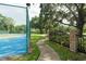 Well-maintained tennis court with paved pathway, offering a beautiful space for recreation and exercise at 102 Brent Cir, Oldsmar, FL 34677