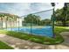 Tennis court surrounded by landscaping offering a great space for recreation and friendly competition at 102 Brent Cir, Oldsmar, FL 34677