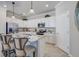 Contemporary kitchen featuring white cabinetry, stainless steel appliances, a breakfast bar, and pendant lighting at 11470 Burgundy Dr, Venice, FL 34293