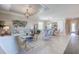 Bright and airy living room with stylish furniture, a decorative ceiling, and an open layout to the dining area at 11470 Burgundy Dr, Venice, FL 34293