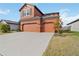 Side view of the exterior showcasing a three-car garage and well-maintained landscaping at 11804 Bluegrass Field Ct, Riverview, FL 33579