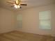 Bright bedroom with carpet flooring, neutral walls, a ceiling fan, and natural light from the windows at 11818 Mango Groves Blvd, Seffner, FL 33584