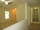 Upstairs hallway with neutral walls, carpet flooring, and natural light from the window at 11818 Mango Groves Blvd, Seffner, FL 33584