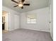 Bright bedroom featuring carpet floors, ceiling fan, and a window at 1337 Coolmont Dr, Brandon, FL 33511