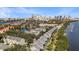 Aerial view of waterfront townhomes near Tampa skyline, nestled among lush greenery with water access and serene setting at 1440 Harbour Walk Rd, Tampa, FL 33602