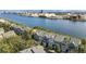 Aerial view of waterfront townhomes with gray roofs, offering stunning water views and close proximity to industrial sites at 1440 Harbour Walk Rd, Tampa, FL 33602