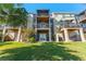 Multi-story building backyard featuring balconies and patios overlooking a manicured lawn, perfect for outdoor relaxation at 1440 Harbour Walk Rd, Tampa, FL 33602