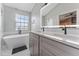 Modern bathroom featuring double vanity, sleek fixtures, and a freestanding soaking tub at 1440 Harbour Walk Rd, Tampa, FL 33602