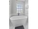 Bright bathroom featuring a freestanding bathtub and marble floors at 1440 Harbour Walk Rd, Tampa, FL 33602