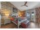 Cozy bedroom featuring a decorative accent wall, a comfortable bed, and stylish furnishings at 1440 Harbour Walk Rd, Tampa, FL 33602