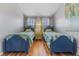 Comfortable bedroom with twin beds, wood floors, and soft lighting at 1440 Harbour Walk Rd, Tampa, FL 33602