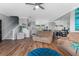 Bright living room with hardwood floors, crown molding, and a staircase leading to the upper level at 1440 Harbour Walk Rd, Tampa, FL 33602