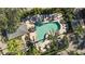 Aerial view of community kidney-shaped pool area with palm trees, lounge chairs, and shade structures, offering resort-style living at 1440 Harbour Walk Rd, Tampa, FL 33602