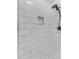 Modern walk-in shower features white subway tile, recessed shelf, and mosaic tile flooring at 1440 Harbour Walk Rd, Tampa, FL 33602