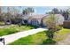 Charming bungalow with a red tile roof, arched window, and well-manicured lawn at 15732 1St E St, Redington Beach, FL 33708