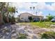 Charming home with a red tile roof, lush landscaping, and ample yard space at 15732 1St E St, Redington Beach, FL 33708