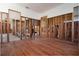 Partially renovated interior showcasing hardwood floors and exposed framing at 15732 1St E St, Redington Beach, FL 33708