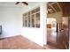 Spacious living room featuring tile flooring, a large window, and a ceiling fan at 15732 1St E St, Redington Beach, FL 33708