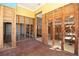 View of a partially renovated living room with hardwood floors and exposed wall framing at 15732 1St E St, Redington Beach, FL 33708