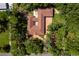 Aerial view of estate surrounded by lush greenery, a stone driveway and unique architecture at 17630 Brown Rd, Odessa, FL 33556