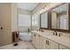 Luxurious bathroom featuring soaking tub, double sink vanity, and travertine floors at 17630 Brown Rd, Odessa, FL 33556