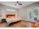 Bedroom with a ceiling fan, French doors to the outside, and wood-look floors at 17630 Brown Rd, Odessa, FL 33556