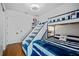 Nautical themed bedroom featuring built-in bunkbeds and stairs to the upper bunk at 17630 Brown Rd, Odessa, FL 33556