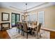 Elegant dining room featuring a tray ceiling, modern chandelier, and stylish accents at 17630 Brown Rd, Odessa, FL 33556