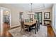 Elegant dining room featuring a tray ceiling, modern chandelier, and sliding glass doors at 17630 Brown Rd, Odessa, FL 33556