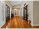 Spacious foyer with hardwood floors, high ceilings, and a unique glass-enclosed wine storage area at 17630 Brown Rd, Odessa, FL 33556