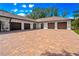 Wide shot of the garages, which have a brick driveway and white exterior walls at 17630 Brown Rd, Odessa, FL 33556