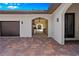 View of the garage and outdoor kitchen area, accessible via covered patio with brick pavers at 17630 Brown Rd, Odessa, FL 33556