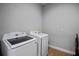 A laundry room with white washer and dryer units, and neutral wall color at 17630 Brown Rd, Odessa, FL 33556