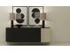 Elegant black console table with modern art, stylish lamps, and decorative elements at 18190 Serene Lake Loop, Lutz, FL 33548