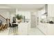 Modern white kitchen with stainless steel appliances and a center island with bar stool seating at 18190 Serene Lake Loop, Lutz, FL 33548