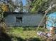 Rear exterior of the home showing the block construction and ladder leaning against the house at 1911 E Noel St, Tampa, FL 33610