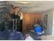 Severely damaged room with debris, damaged ceiling, and contents strewn about the space at 1911 E Noel St, Tampa, FL 33610