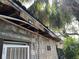 Close up of the damaged roof and siding of the home's exterior at 1911 E Noel St, Tampa, FL 33610