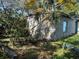 Exterior view of a backyard shed surrounded by overgrown vegetation at 1911 E Noel St, Tampa, FL 33610