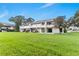 The backyard exterior shows a lovely green lawn and an immaculate white building at 2075 Lakewood Club S Dr # 6A, St Petersburg, FL 33712