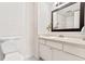 Cozy bathroom with neutral vanity, sink, and a large mirror at 2075 Lakewood Club S Dr # 6A, St Petersburg, FL 33712