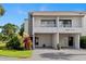 Clean two-story condo featuring a balcony, covered parking, and tidy landscaping at 2075 Lakewood Club S Dr # 6A, St Petersburg, FL 33712