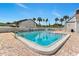 Community swimming pool with plenty of lounge chairs, palm trees, and manicured shrubbery at 2075 Lakewood Club S Dr # 6A, St Petersburg, FL 33712