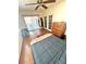 Bedroom featuring wood floors, a ceiling fan, and a double bed near a sliding glass door to the porch at 2172 University S Dr, Clearwater, FL 33764