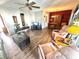 Open concept living room with wood floors, a ceiling fan, and a red accent wall with shelving at 2172 University S Dr, Clearwater, FL 33764